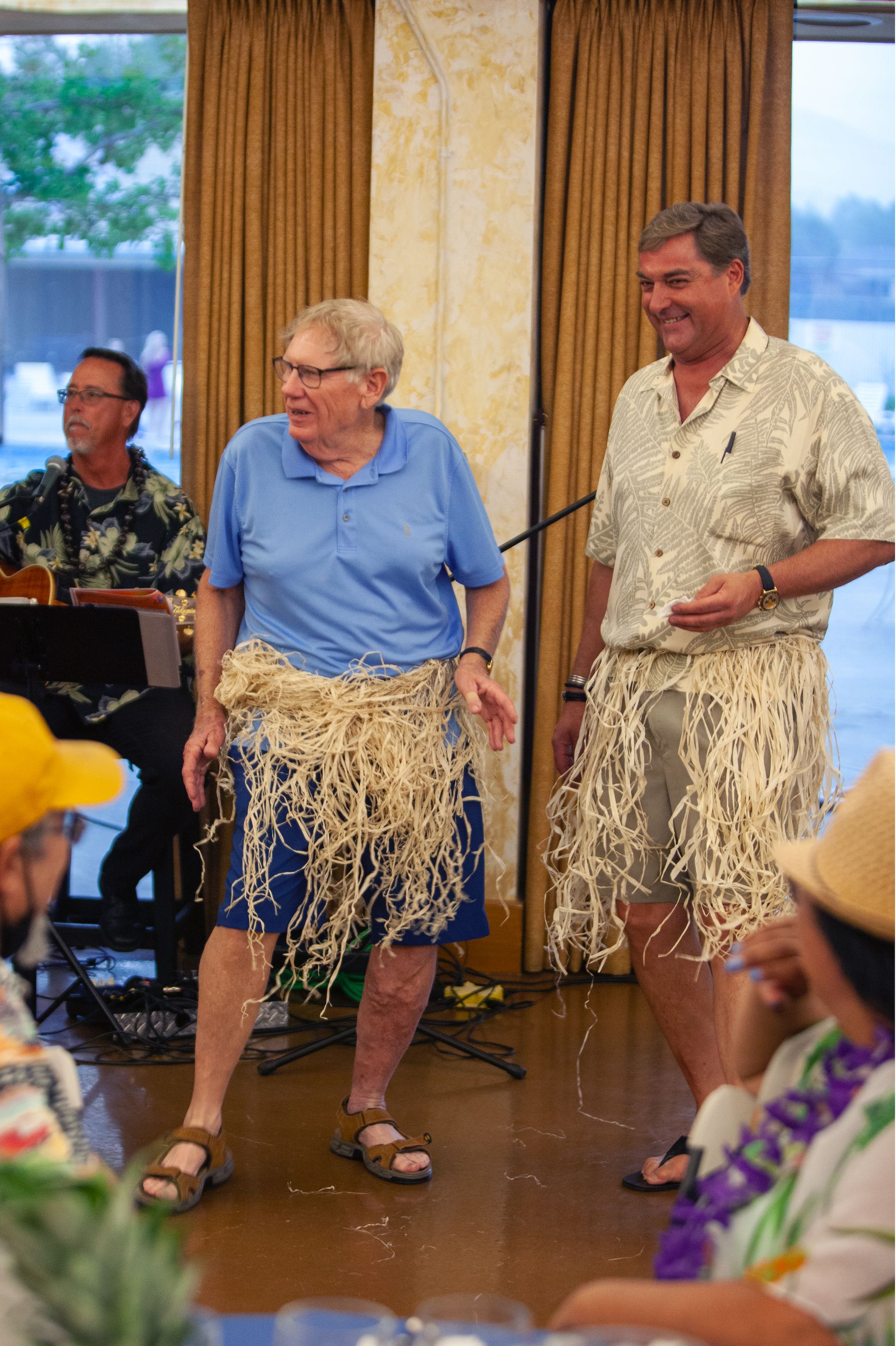 Randy Elliott and Jeffrey Lowden in hula skirts at the Optimist Club of Reno Luau.